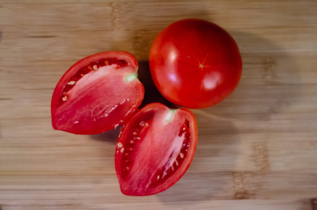 A sliced tomato ready to harvest tomato seeds - no ferment method